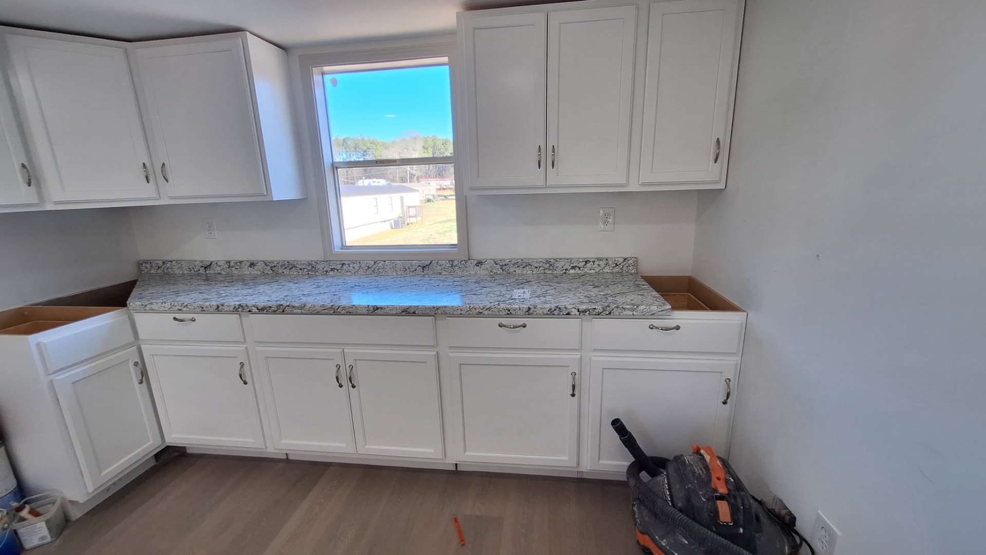 White cabinetry and granite install