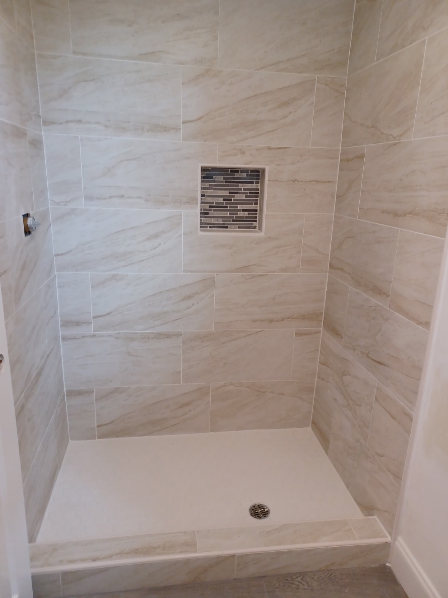 BTZ Remodeling craftsman fitting custom trim carpentry with a level and tape measure