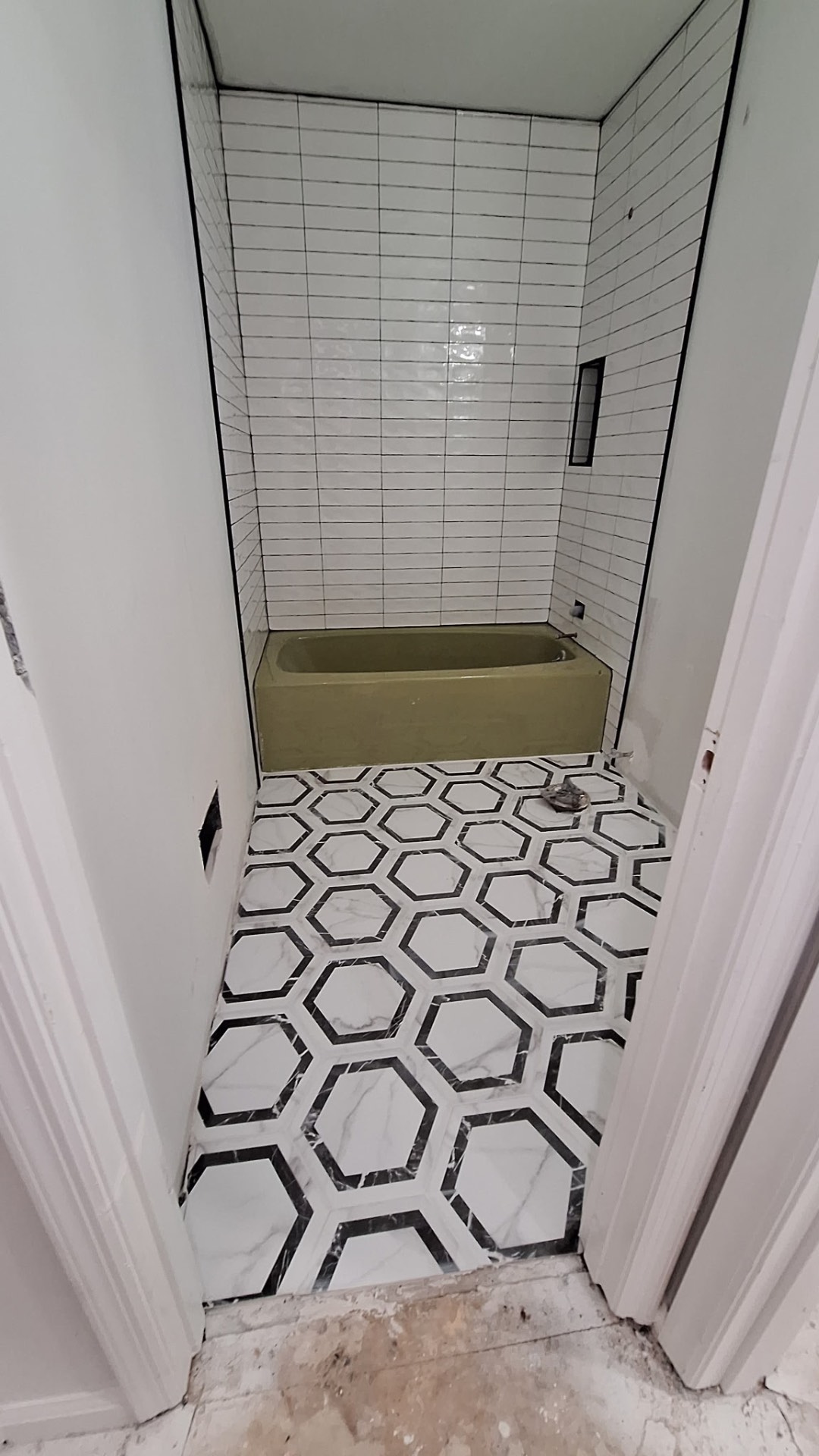 Subway tile tub and hex tile floor