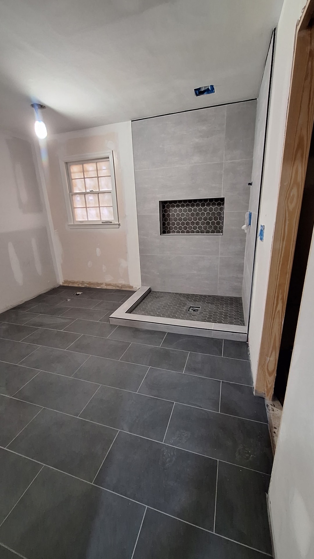 Curbed shower and large-format floor tile